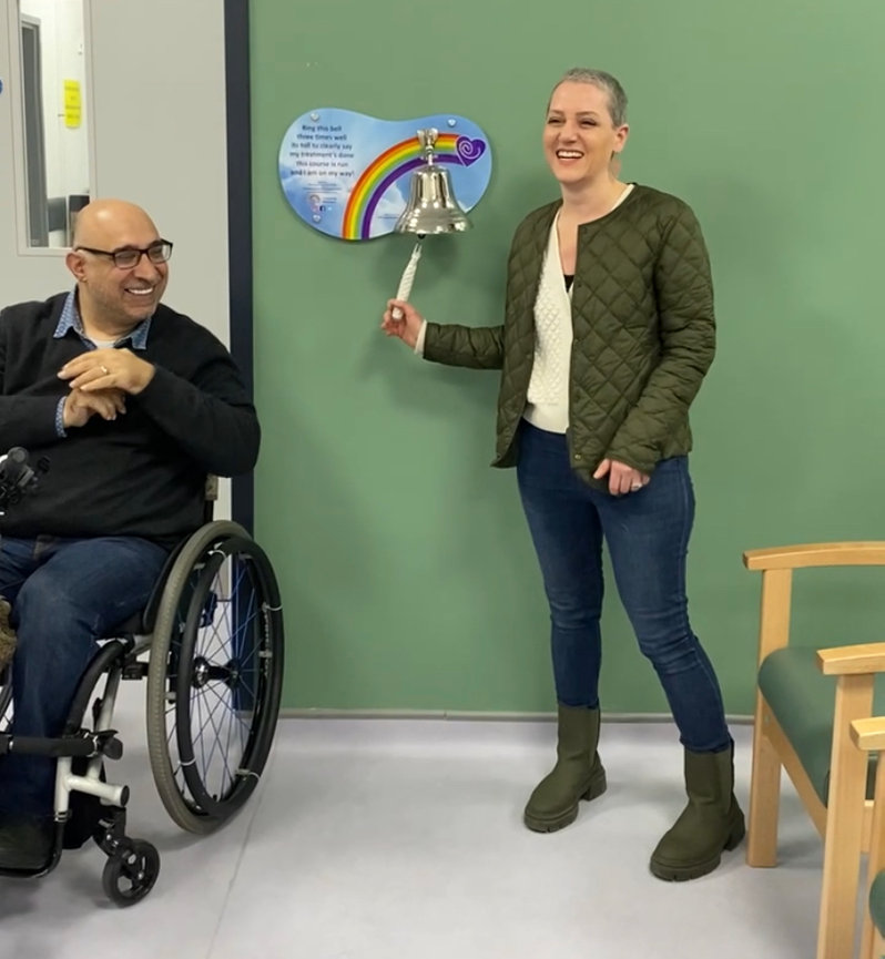 Kristen rings the bell at the hospital to celebrate completing her cancer treatment program